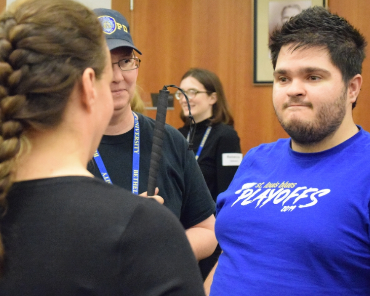 Young man talking with adult.